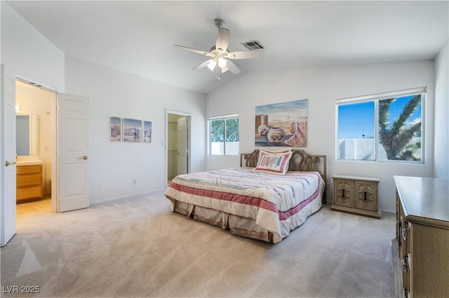 bedroom featuring visible vents, ensuite bathroom, a ceiling fan, lofted ceiling, and light colored carpet