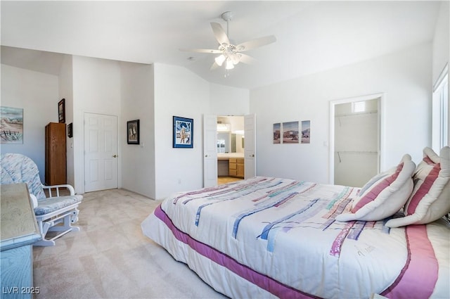 bedroom with a spacious closet, lofted ceiling, light carpet, a closet, and a ceiling fan