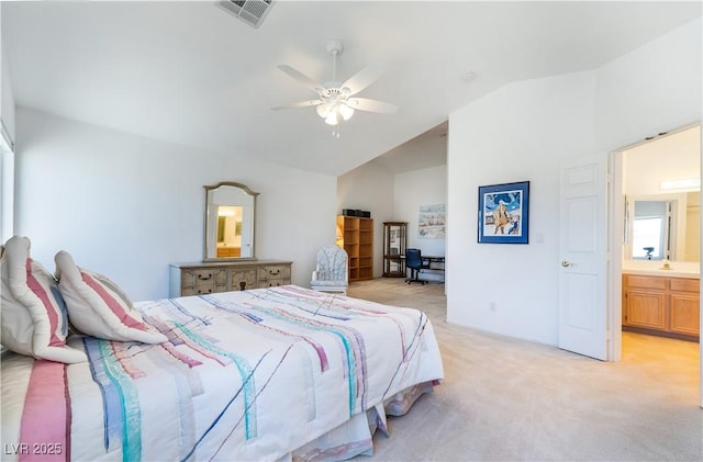 bedroom with visible vents, light carpet, a ceiling fan, connected bathroom, and vaulted ceiling