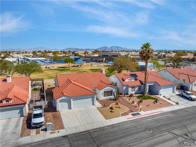 drone / aerial view featuring a residential view and a mountain view