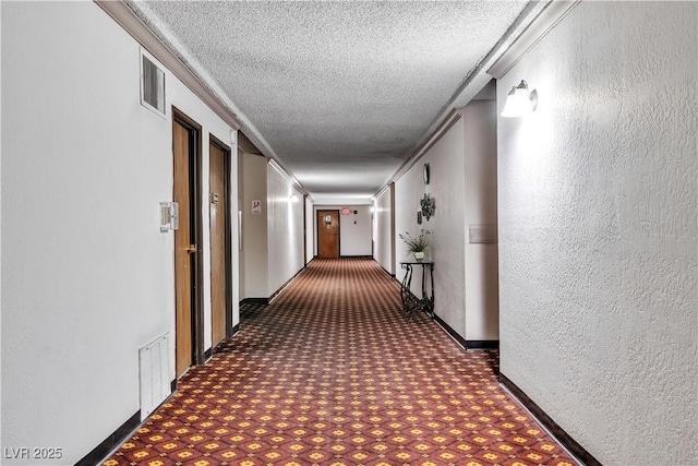 hallway with a textured wall and visible vents