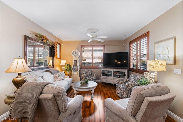 living area featuring baseboards, a healthy amount of sunlight, and hardwood / wood-style flooring