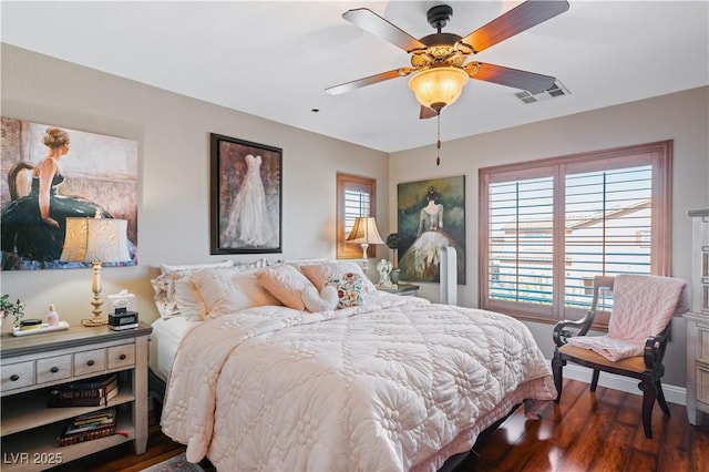 bedroom with a ceiling fan, wood finished floors, and visible vents