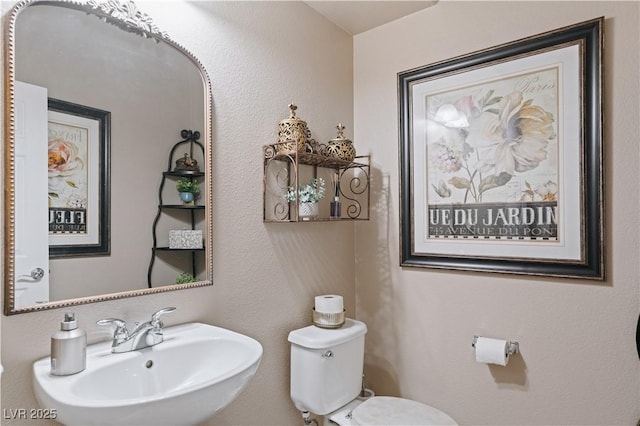 bathroom with toilet and a sink