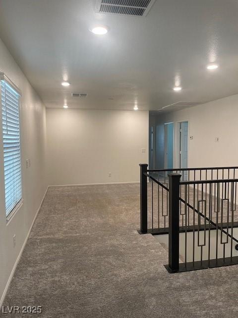 unfurnished room featuring recessed lighting, visible vents, baseboards, and carpet flooring