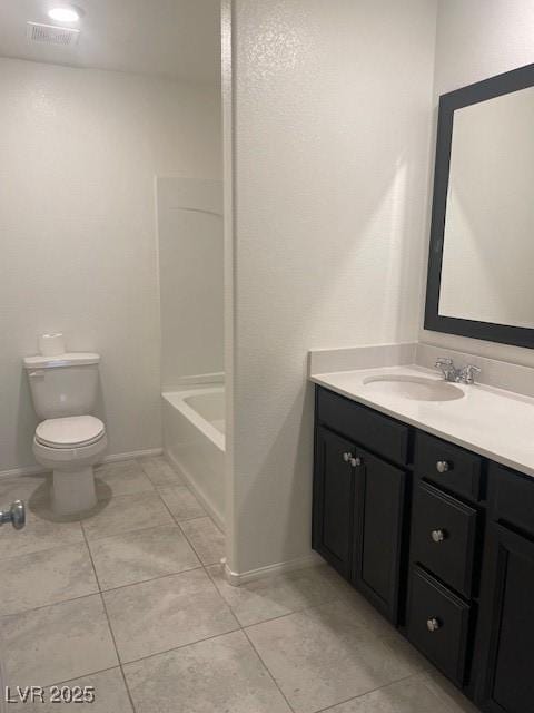 bathroom featuring vanity, toilet, visible vents, and tile patterned flooring