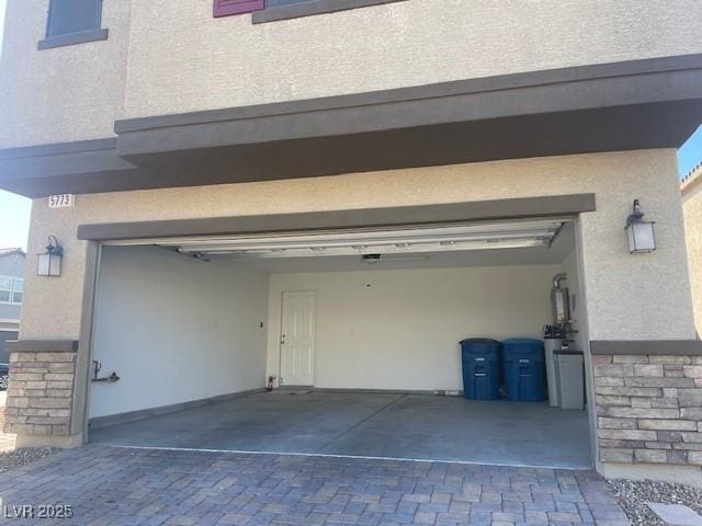 garage featuring decorative driveway