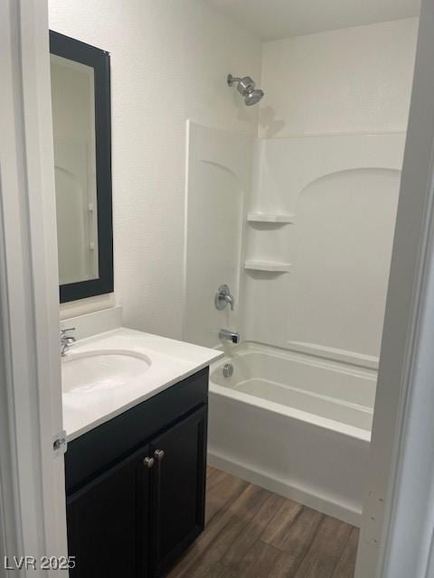 bathroom featuring vanity, shower / tub combination, and wood finished floors