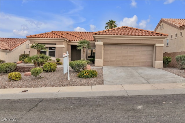 mediterranean / spanish home with concrete driveway, a tiled roof, a garage, and stucco siding