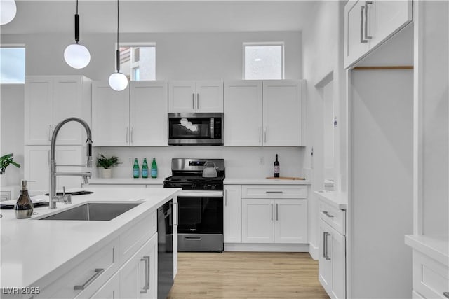 kitchen featuring a sink, white cabinetry, appliances with stainless steel finishes, and light countertops