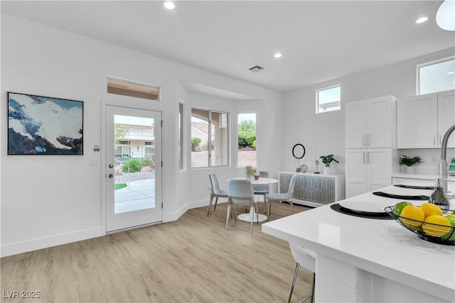 dining room featuring recessed lighting, visible vents, light wood-style flooring, and plenty of natural light