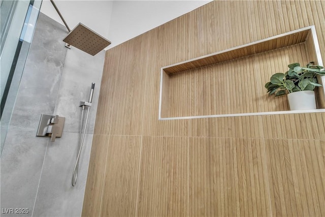 interior details featuring tiled shower