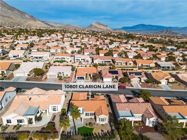 drone / aerial view featuring a residential view and a mountain view