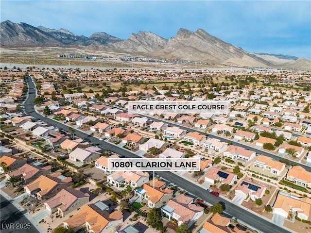 drone / aerial view featuring a residential view and a mountain view