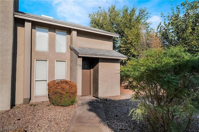 property entrance featuring stucco siding