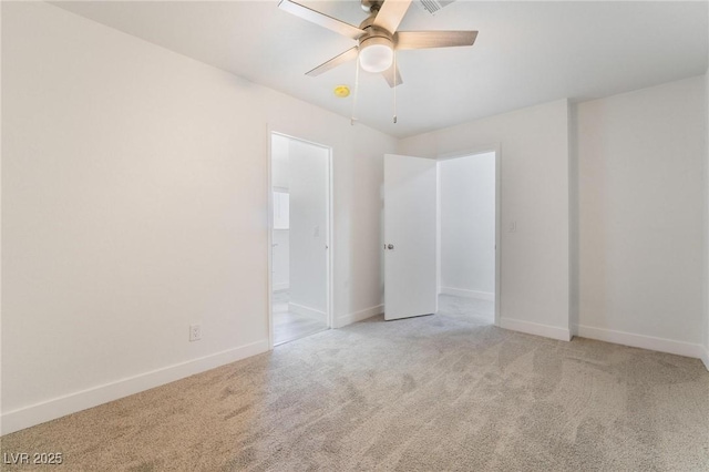 unfurnished bedroom featuring connected bathroom, a ceiling fan, baseboards, and light carpet