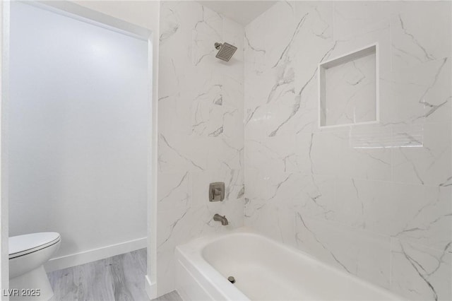 bathroom with toilet, shower / bath combination, baseboards, and wood finished floors