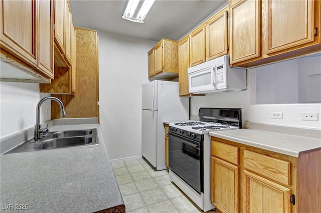 kitchen featuring a sink, white appliances, light floors, and light countertops