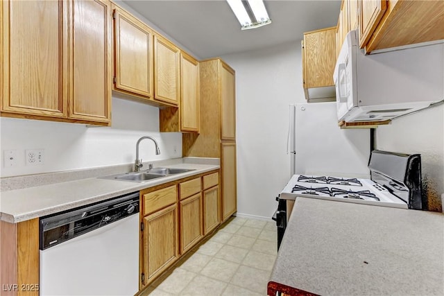 kitchen with light floors, white appliances, light countertops, and a sink