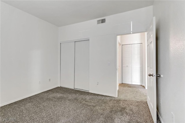 unfurnished bedroom featuring a closet, visible vents, carpet flooring, and baseboards