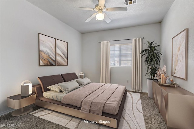 carpeted bedroom featuring baseboards, visible vents, a textured ceiling, and ceiling fan