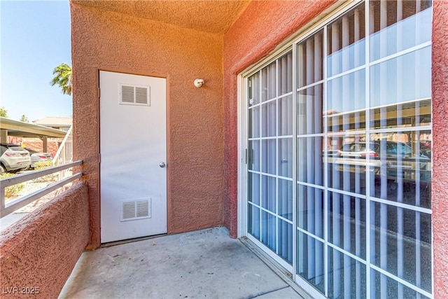 property entrance featuring stucco siding