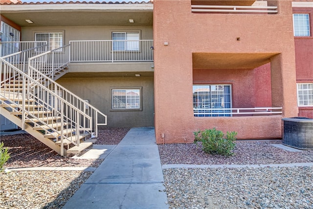 view of property featuring stairway and central AC