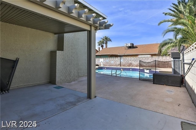 view of swimming pool featuring a fenced in pool, a patio, and fence