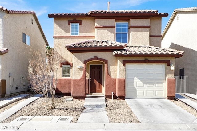 mediterranean / spanish-style home featuring concrete driveway, an attached garage, and stucco siding