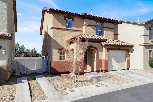 mediterranean / spanish-style home featuring stucco siding, driveway, and a gate