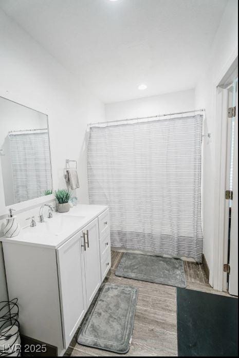 bathroom with wood finished floors and vanity