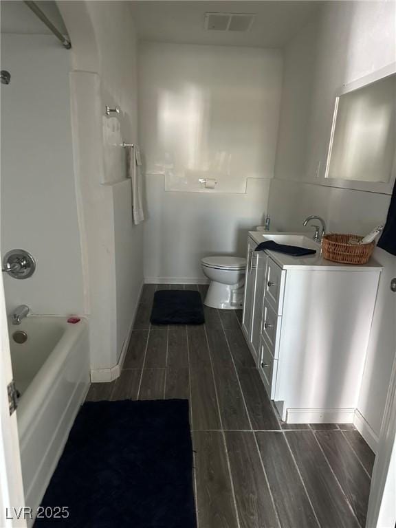 bathroom featuring visible vents, wood finish floors, toilet, shower / bathtub combination, and vanity