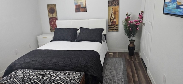 bedroom featuring baseboards and wood finished floors