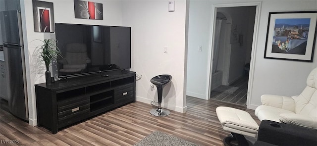 living room featuring baseboards and wood finished floors