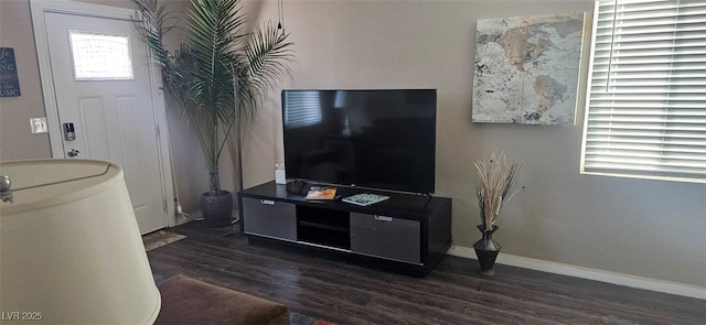 living area with wood finished floors and baseboards