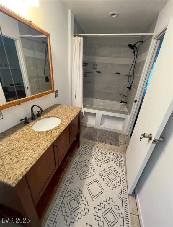 full bathroom featuring tile patterned flooring, shower / bath combination with curtain, and vanity