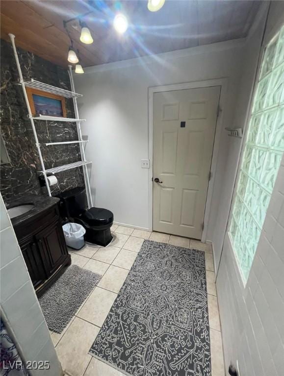 bathroom featuring tile patterned flooring, toilet, and vanity