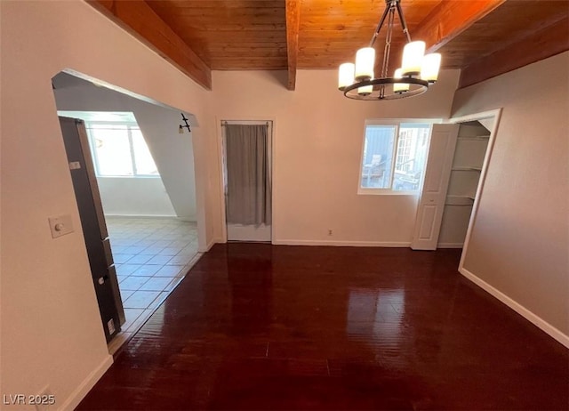 empty room featuring wood finished floors, baseboards, an inviting chandelier, beam ceiling, and wood ceiling