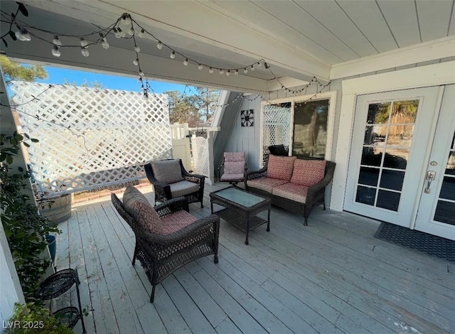 wooden terrace featuring fence and an outdoor hangout area