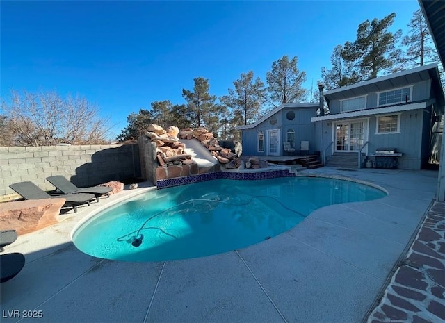 view of pool with french doors, a patio, a fenced in pool, and fence