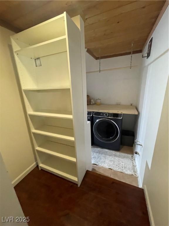 laundry room featuring washer / clothes dryer, wood ceiling, and baseboards