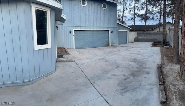 view of home's exterior with fence and a garage