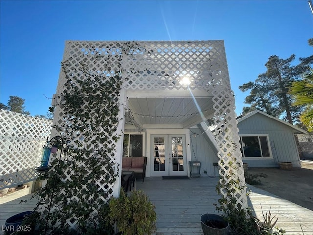 back of property with french doors and a wooden deck