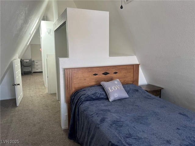 carpeted bedroom featuring vaulted ceiling