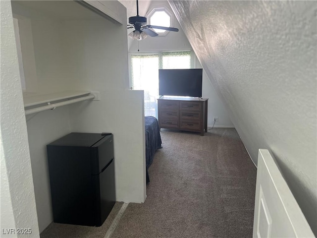 carpeted bedroom with refrigerator and ceiling fan