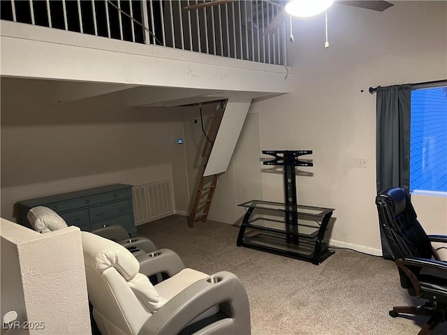 interior space featuring baseboards, carpet floors, visible vents, and a ceiling fan