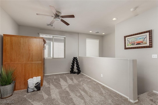 carpeted empty room with recessed lighting, a ceiling fan, and baseboards