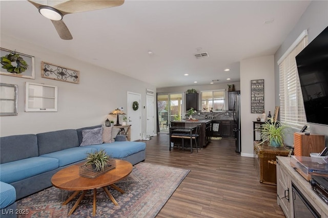 living area featuring visible vents, a ceiling fan, dark wood-style floors, recessed lighting, and baseboards