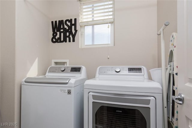 washroom featuring laundry area and separate washer and dryer