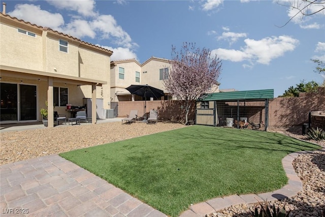 view of yard with a patio area and a fenced backyard